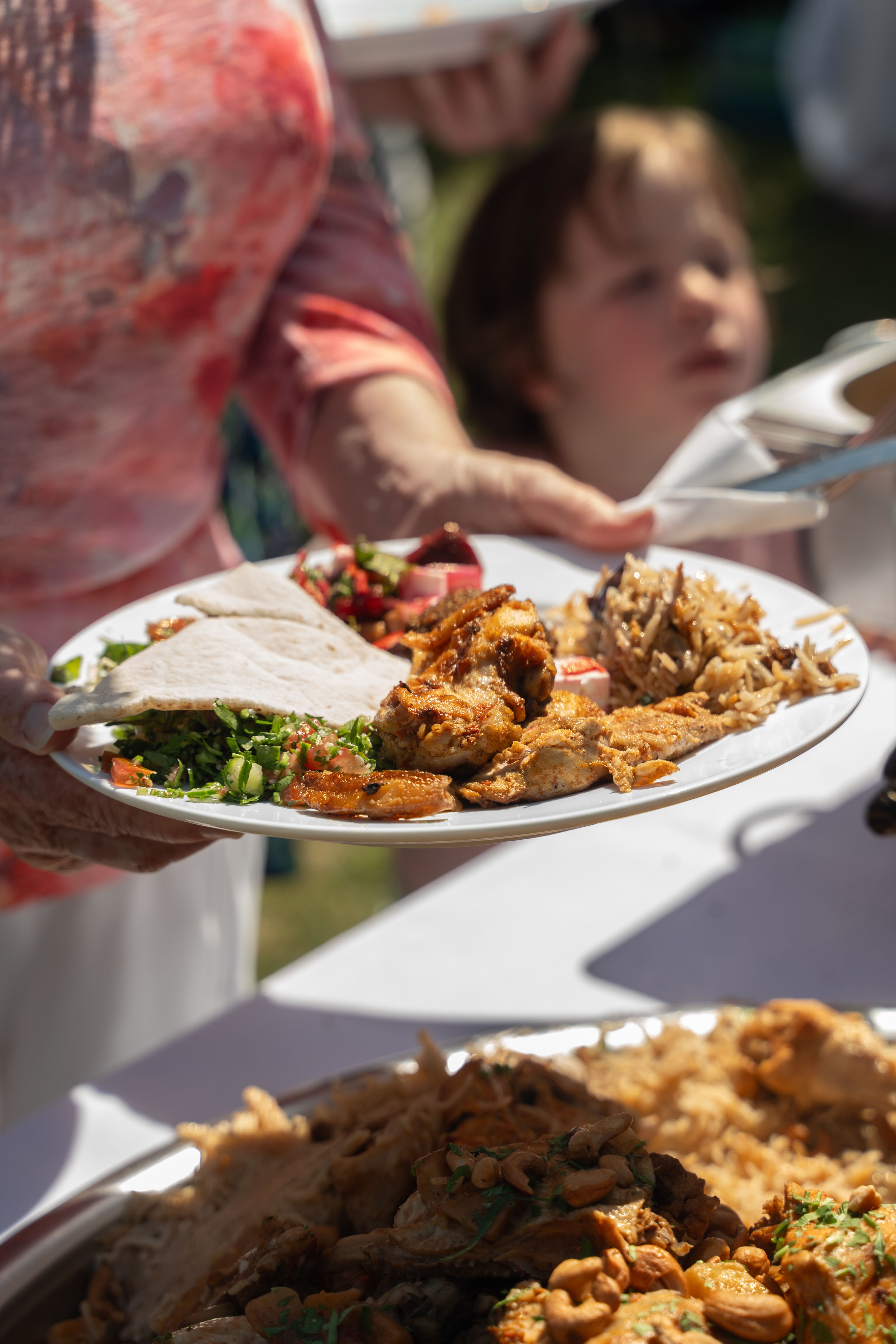 Catering event photography of a plated meal served outdoors