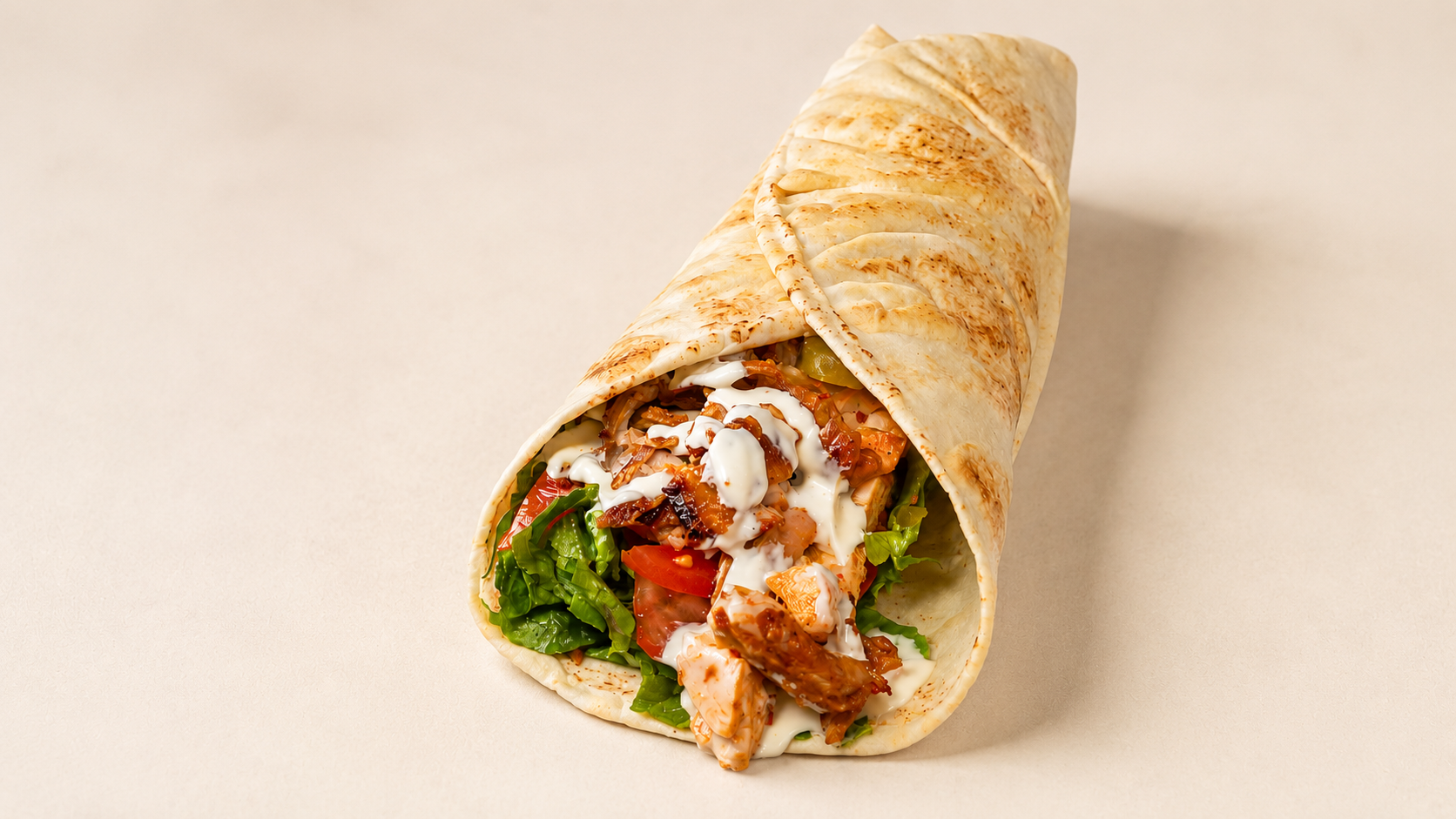 Chicken wrap photographed on a clean background for a restaurant advertising campaign